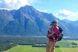 Father with toddler daughter near mountains in Alaska. Family Vacation Ideas USA.