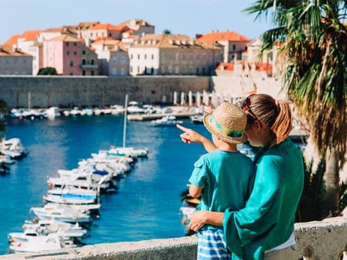 A mom and her son look across the port of Dubrovnik's Old City.