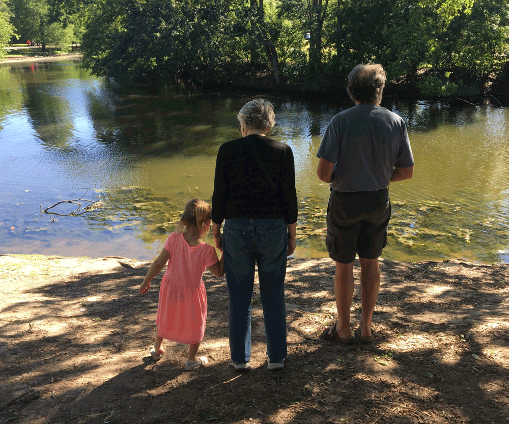 Little girl with grandparents on vacation in Audubon Park in New Orleans