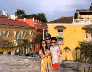Cartagena Vacation Kids, Dad with kids against yellow buildings in Cartagena vacation with kids
