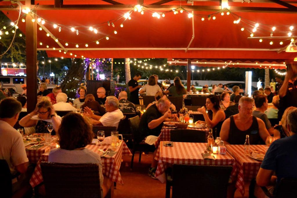 Inside Casa Tua Renaissance, featuring twinkle lights and full tables.