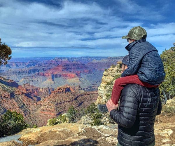 A child on the shoulder of his dad while taking in the views at the Grand Canyon.