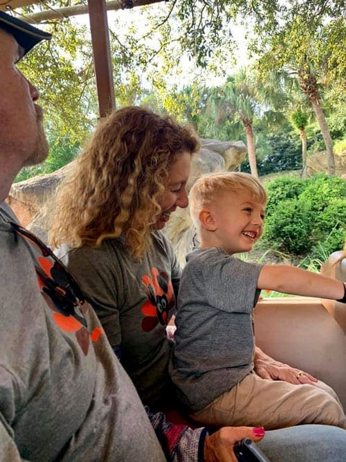 Little boy with her parents in the jeep