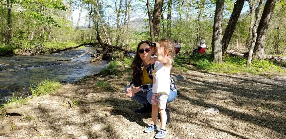 Mom and daughter in Great Smoky Mountains National Park, one of the best affordable summer vacations in the United States with kids.