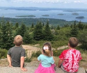 Three children on a hike enjoying the view at Acadia National Park