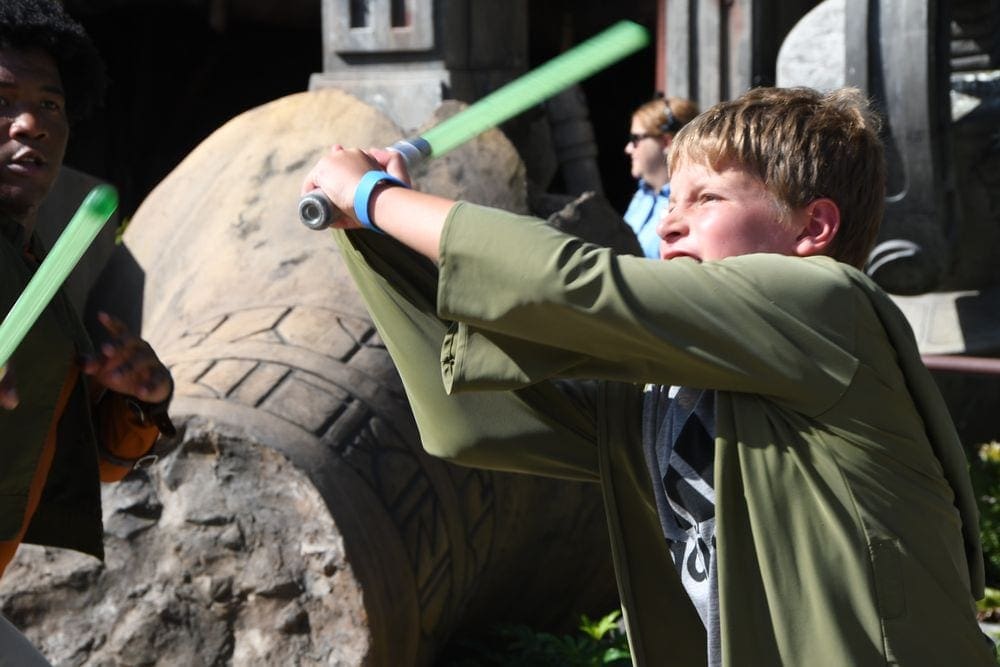 A kid doing Jedi training at Disney Hollywood Studios.