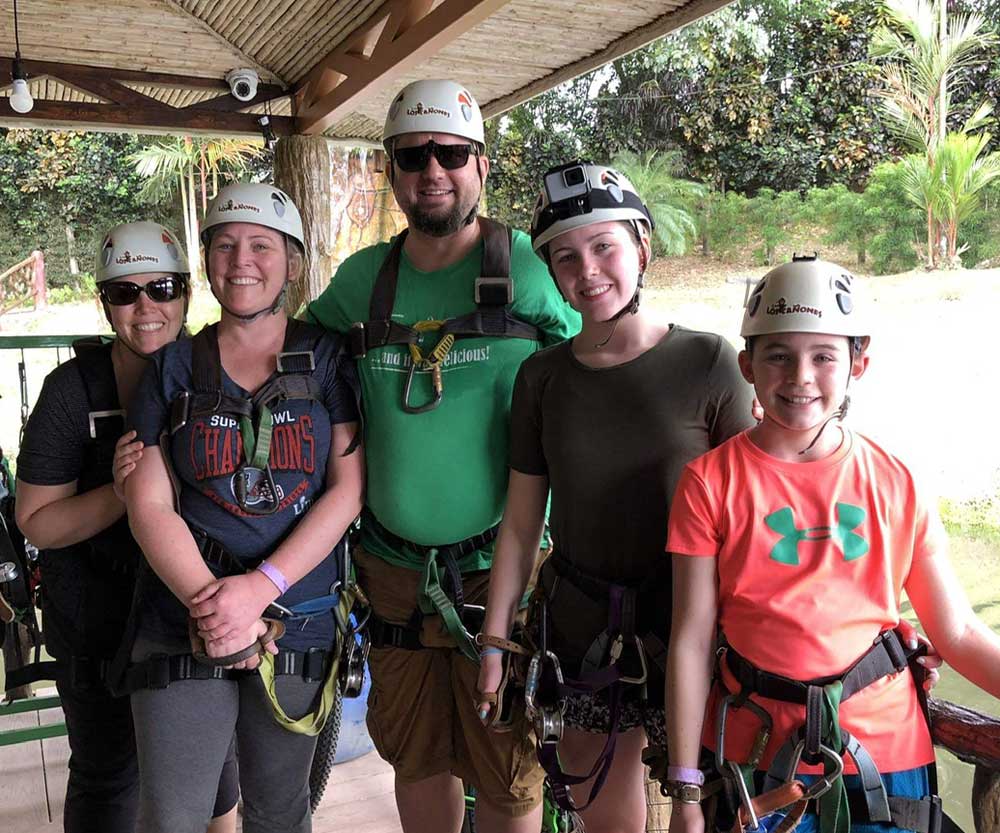 A family wearing helmets and gear before going zip lining in Costa Rica