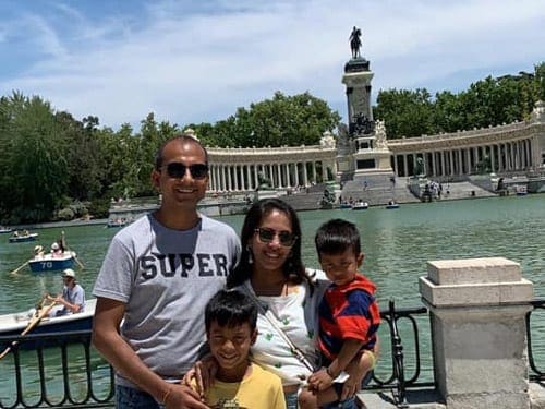 A family of four stands together in Madrid.