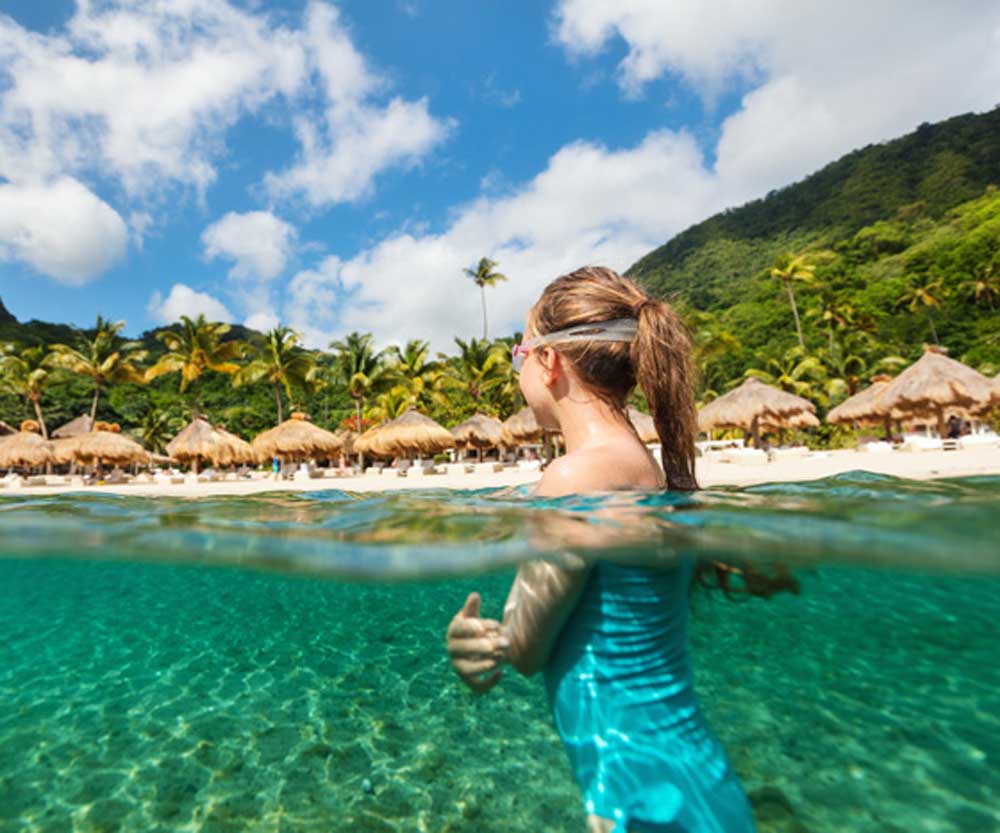 Girl in clear water on St. Lucia family vacation.