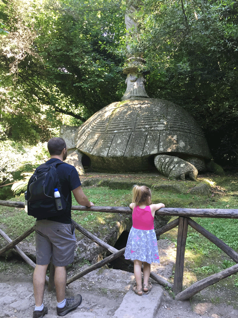 Dad and daughter playing in Monster Park Bomarzo, one of the best things to do near Rome with toddlers.