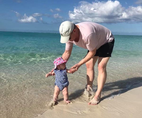 Father and daughter on the beach in Turks and Caicos.