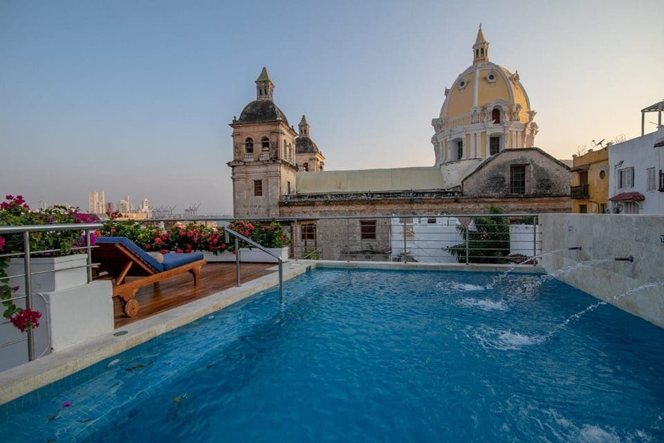 The rooftop pool at the Casa Claver Loft Boutique Hotel, featuring a view of the city.
