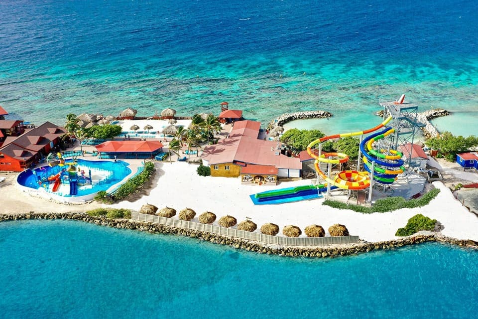 An aerial view of De Palm Island, featuring white sand beaches, clear water, and a huge water park.