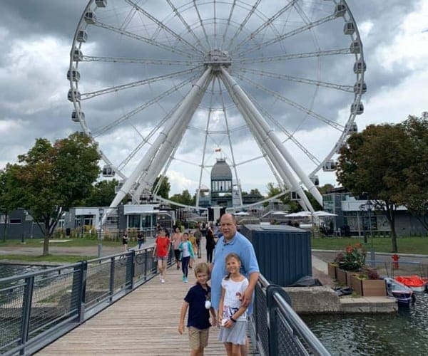 Family in front of Ferris Wheel
