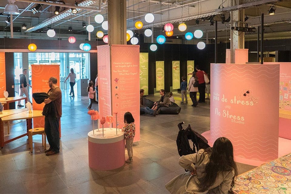 Several people explore an exhibit inside the Montreal Science Centre.