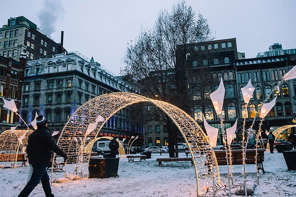 Old Montreal during the winter, featuring lights and cloudy skies.