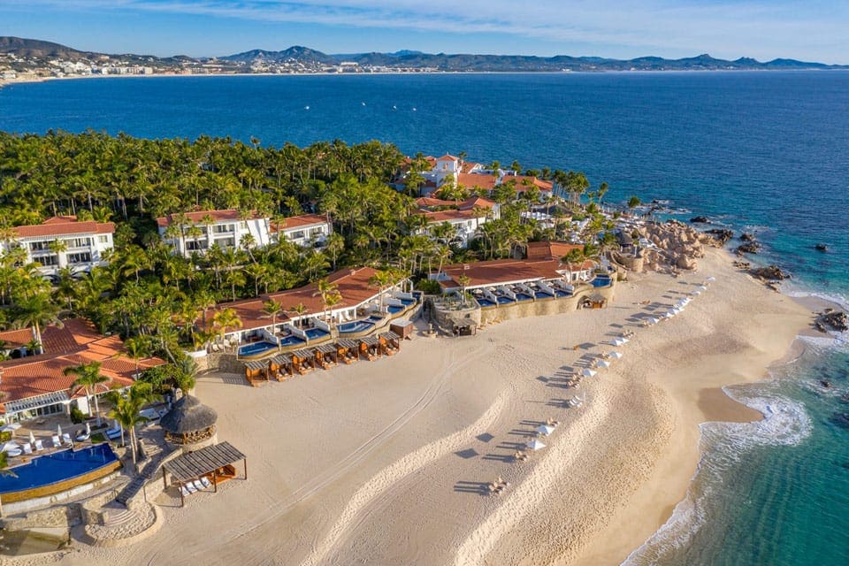 An aerial view of One and Only Palmilla, featuring stunning grounds, white sand beaches, and cabanas.