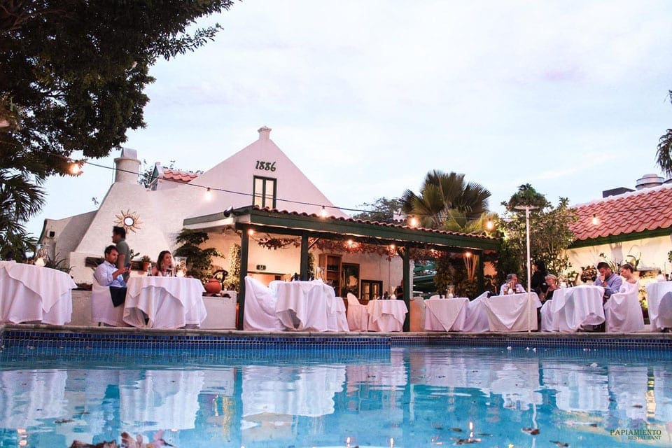 The outdoor tables, across a peaceful pool, at Papiamento