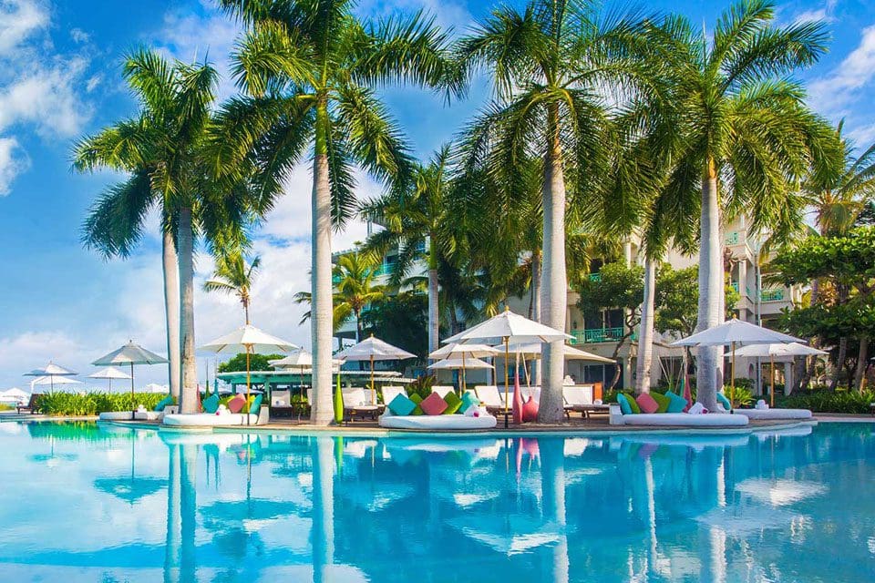 The pool at The Palms Turks and Caicos, with cabanas in the background.