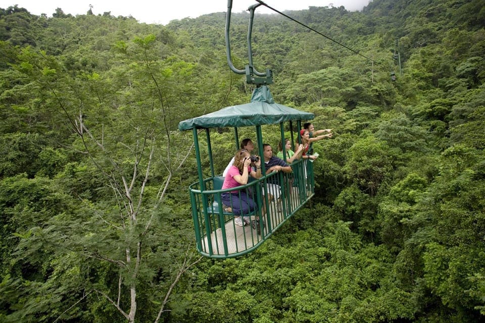 Several people look out from a gondola during a Rainforest Adventour Tour in Costa Rica.