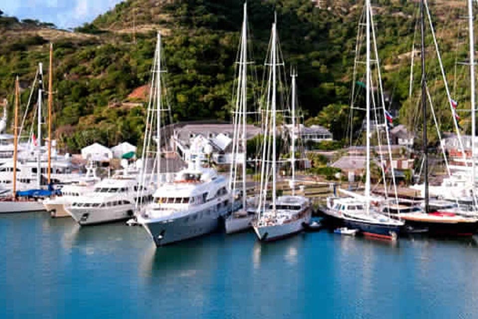 Several boats are parked in the marina near the Visit Nelson’s Dockyard National Park.