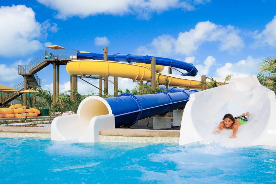 A child slides down a large outdoor waterslide at Beaches Turks & Caicos.