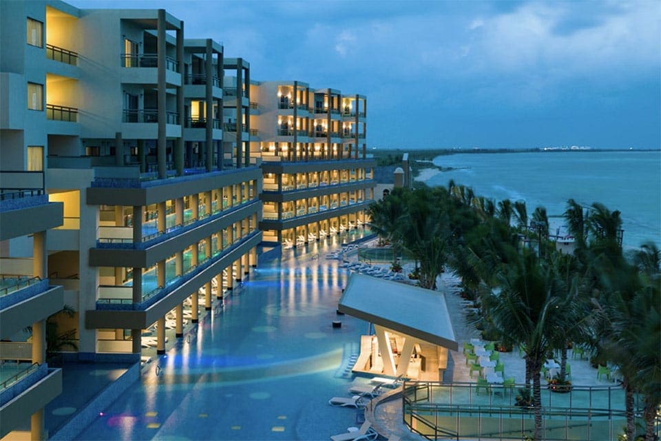 An outdoor view of Generations Riviera Maya at night, one of the best resorts in Playa del Carmen.