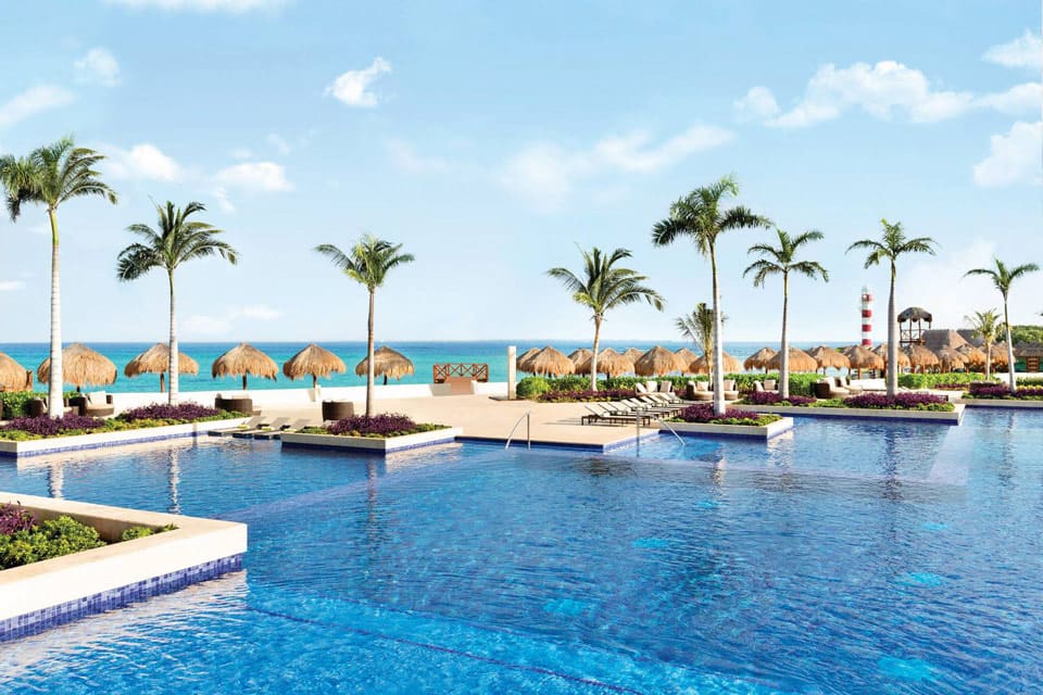 A stunning view of the resort pool at Hyatt Ziva Cancun, vacation with kids. Gorgeous pools make the Hyatt Ziva one of the best family resorts in Cancun.