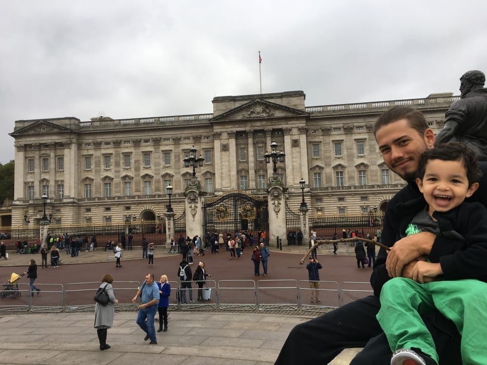 Father and son outside of Buckingham Palace.