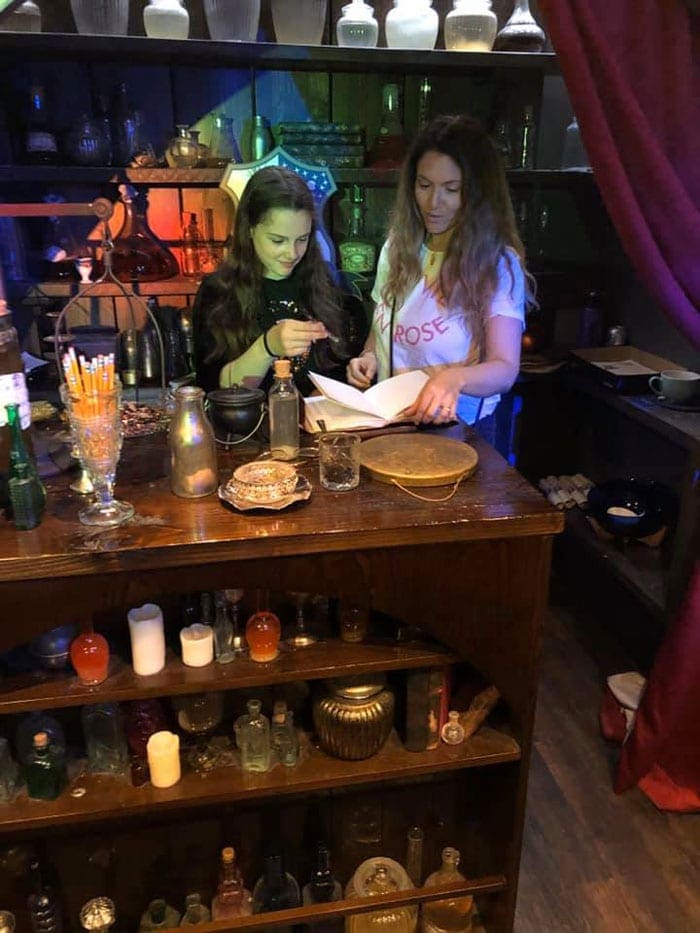 A mom and her young daughter enjoy tea time in London at the Potion Room, one of the most kid-friendly tea places in London.