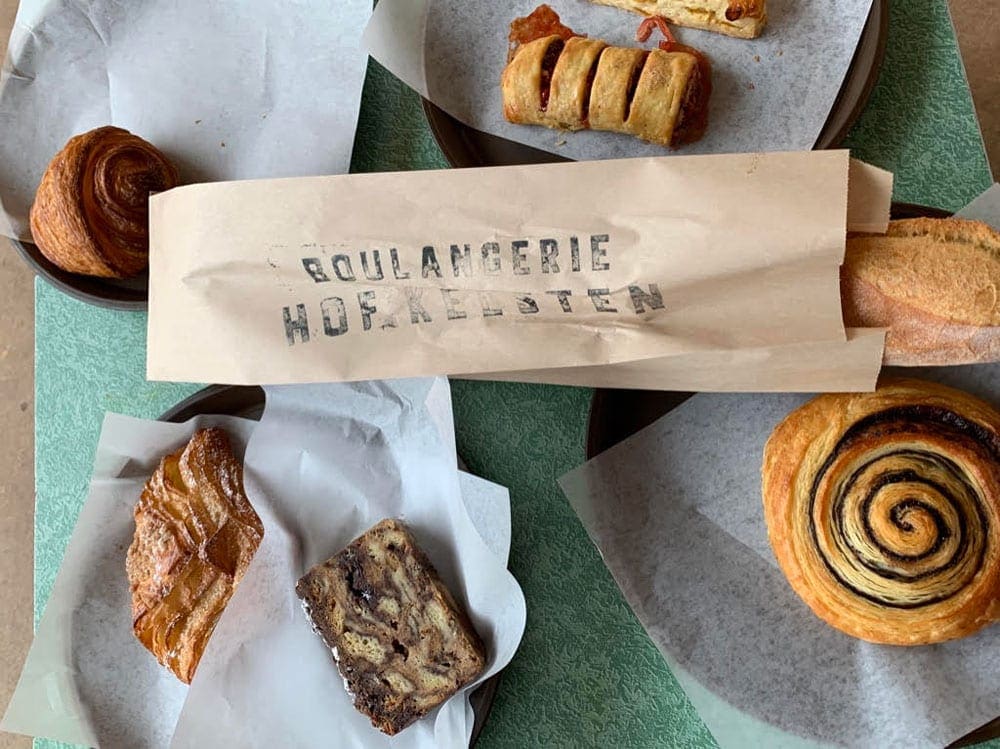 A table laden with sweets and breakfast items from Boulangerie Pastries in Montreal.