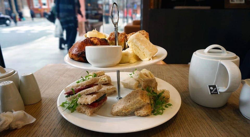 Cooking is one of the best ways to seek Virtual Travel from Home to London. Picture of a lovely tea-time spread in London, including scones and tea. 