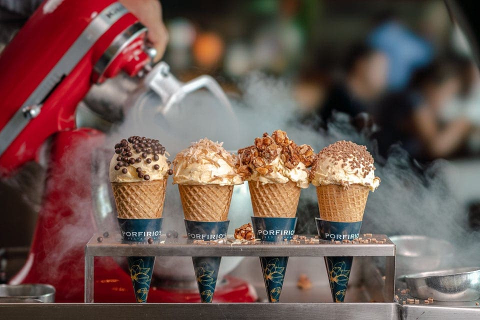 A red cuisinart mixer sits behind four perfectly crafted ice cream cones held within a dish at Porfirio’s Restaurante, one of the best restaurants in Cancun with kids.