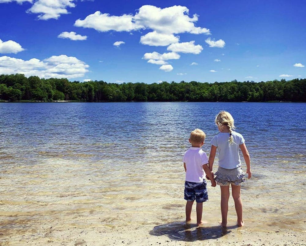 Little boy and girl admiring the view and playing in the water at Lake Noami in PA