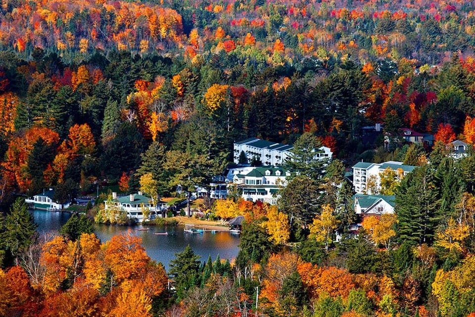 An aerial view of Mirror Lake Inn Resort & Spa, featuring incredible fall foliage, one of the best family resorts in New York State.
