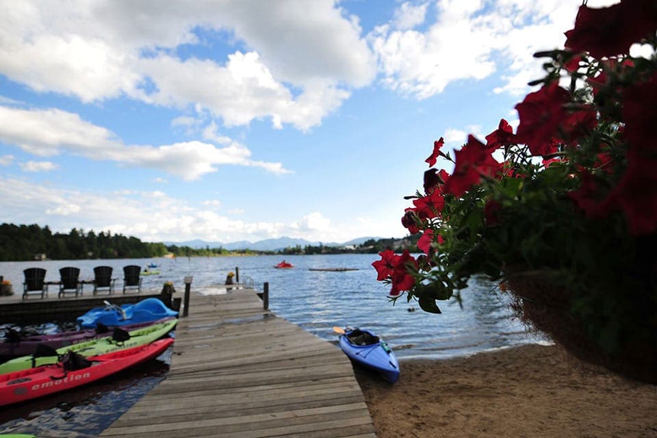 Colorful canoes near dock and water at Mirror Lake Inn.