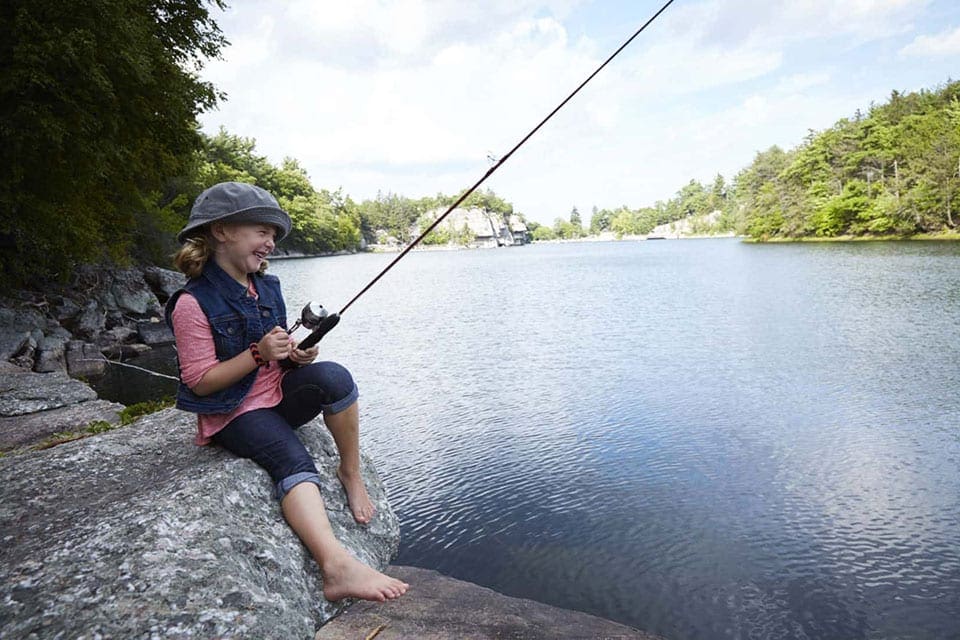 Little girl fishing at Lake Mohonk at the Mohonk Mountain House.