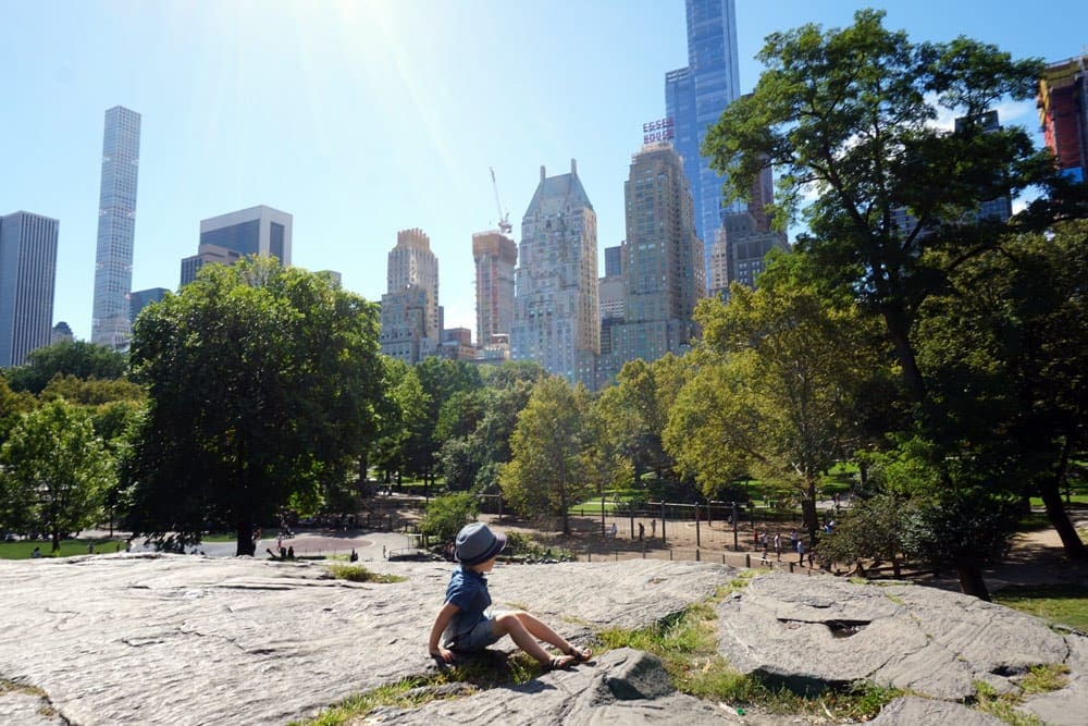 Little boy on rocks in Central Park in NYC.