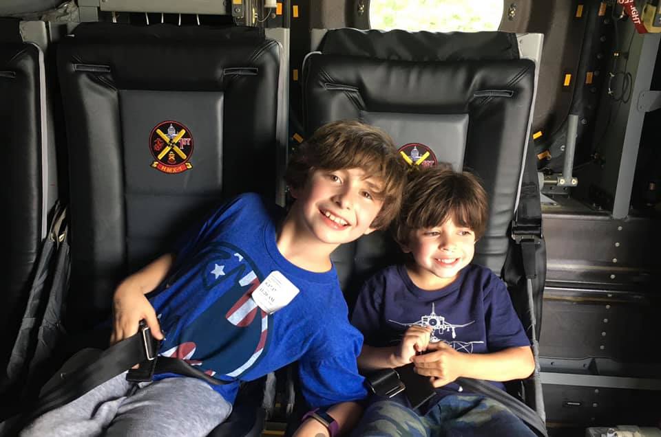 Two young boys sit in an exhibit at the Smithsonian’s Air & Space Museum. One of the 9 Things to Do Washington DC with Kids.