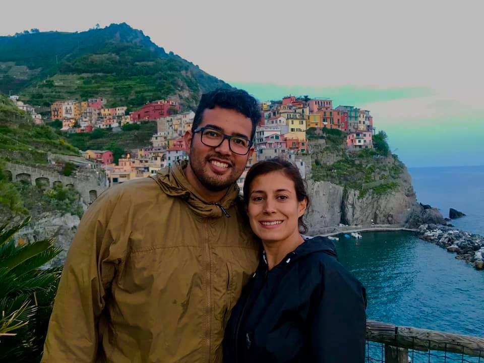 Couple stands in front of one of Cinque Terre, one of the Best Colorful Towns for Families.