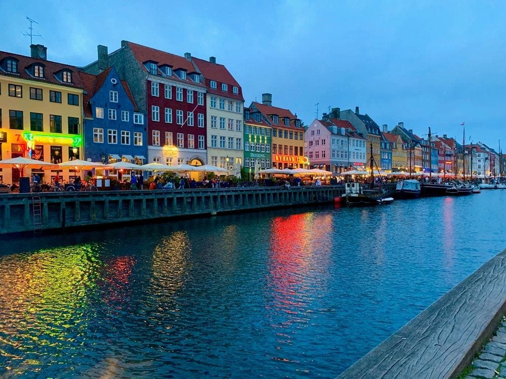 A night view of the colorful outdoor waterfront scene in Copenhagen Denmark