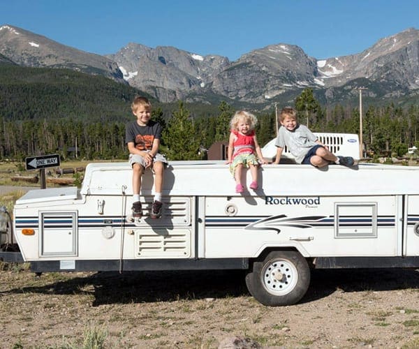 Three kids sitting in a trailer-Family RVing 
