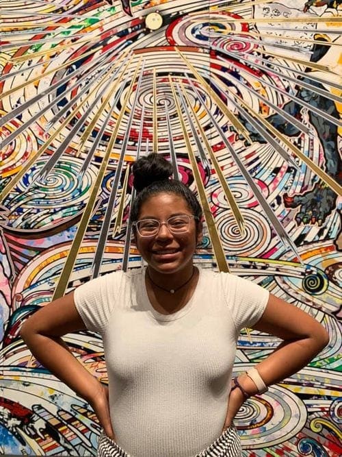 A young girl stands in front of a modern paiting at the National Gallery.