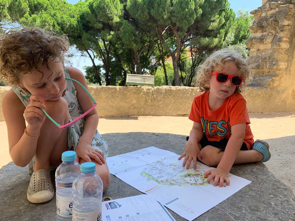 Two little ones looking at a map near St. Georges Castle.