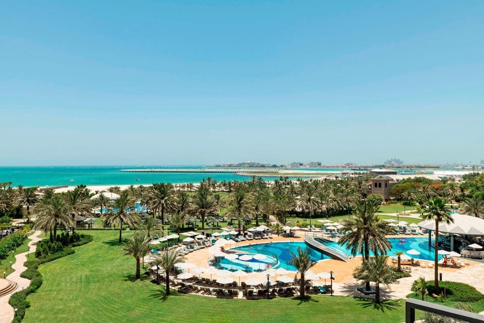 An aerial view of the outdoor pools at the Le Méridien Mina Seyahi Beach Resort & Waterpark.