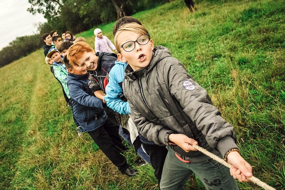 Kids pulling a rope game a kids camp