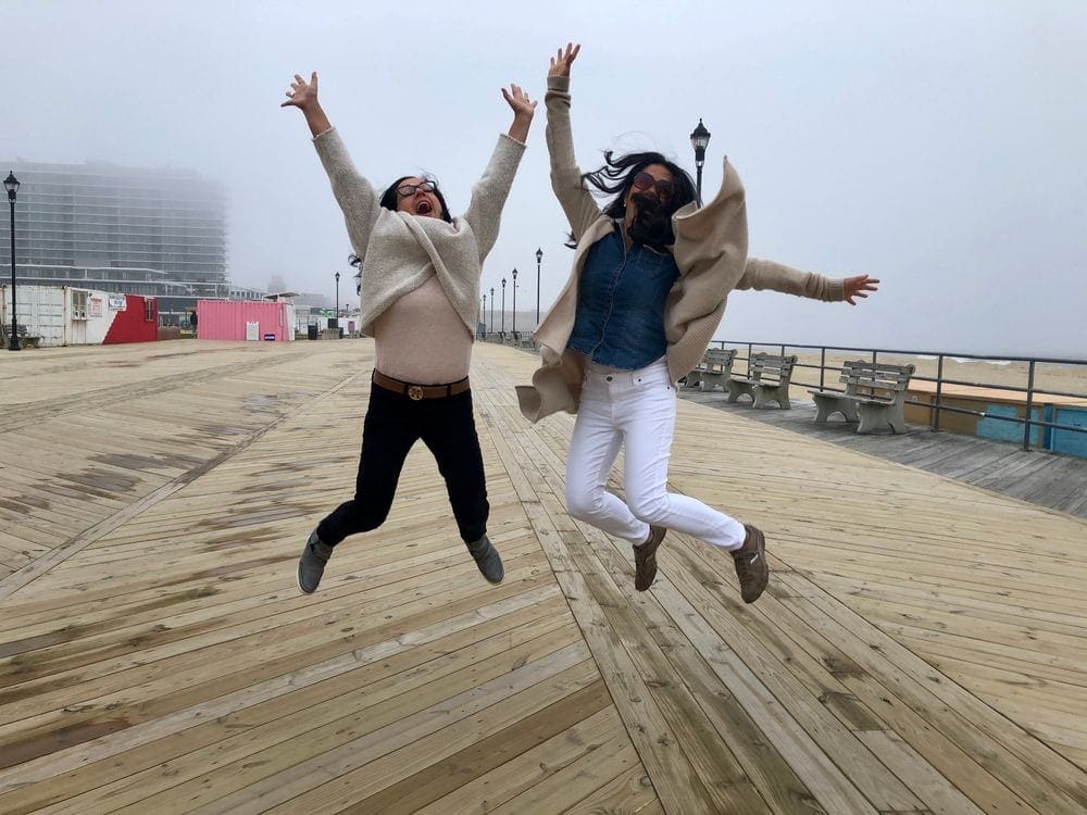 A mother and daughter job with joy along the boardwalk of Asbury Beach.