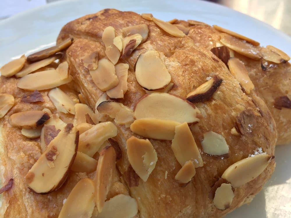 A close up view of an almond croissant.