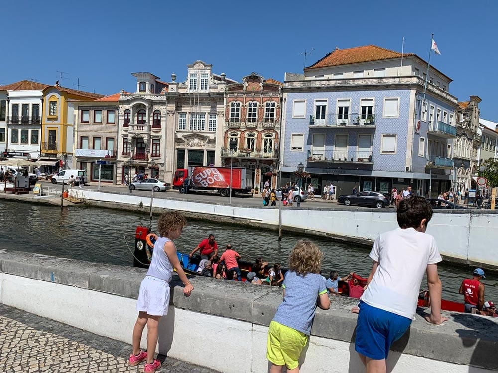 Three siblings overlooking water in Portugal