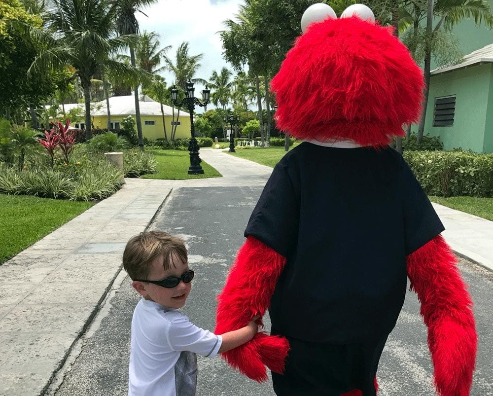 Little Boy holding hand of Elmo at Beaches Turks and Caicos